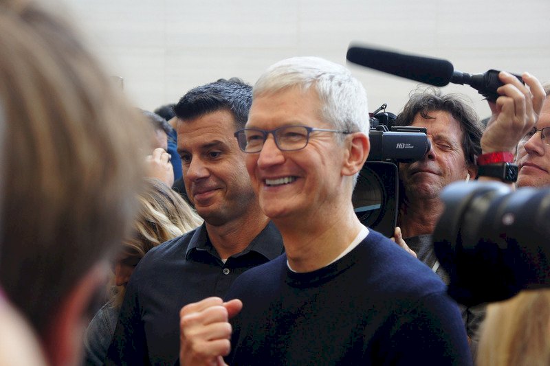 蘋果公司日前在美國總部的賈伯斯劇院發表新iPhone,執行長庫克(中)在新品體驗區被人潮包圍,露出自信的笑容。