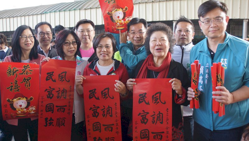 農曆春節將屆,總統府祕書長陳菊(前右2)等人18日在高雄火車站發放總統府春聯,向民眾拜早年。