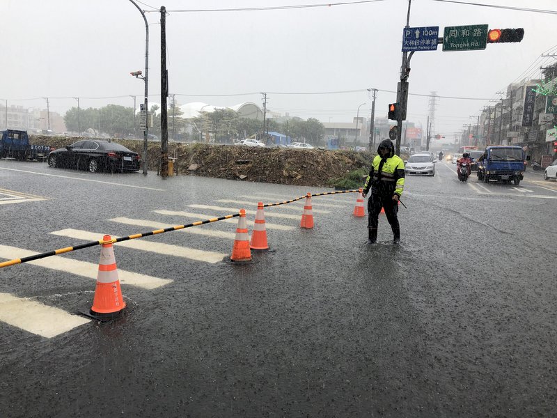 颱風哈格比帶來豐沛雨量,桃園市部分路段3日中午出現積水情況,警方除緊急擺設交通錐進行區隔,也加派人手指揮管制。(桃園市警察局八德分局提供)