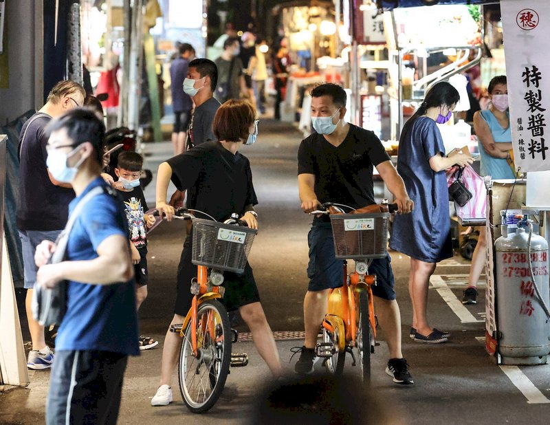 本土疫情尚未完全退燒,3級警戒狀態持續,不過時值假日,加上民眾似乎悶得太久,台北饒河街夜市20日晚間人氣略回溫,有許多民眾前來外帶攤販餐點。 (圖:中央社)